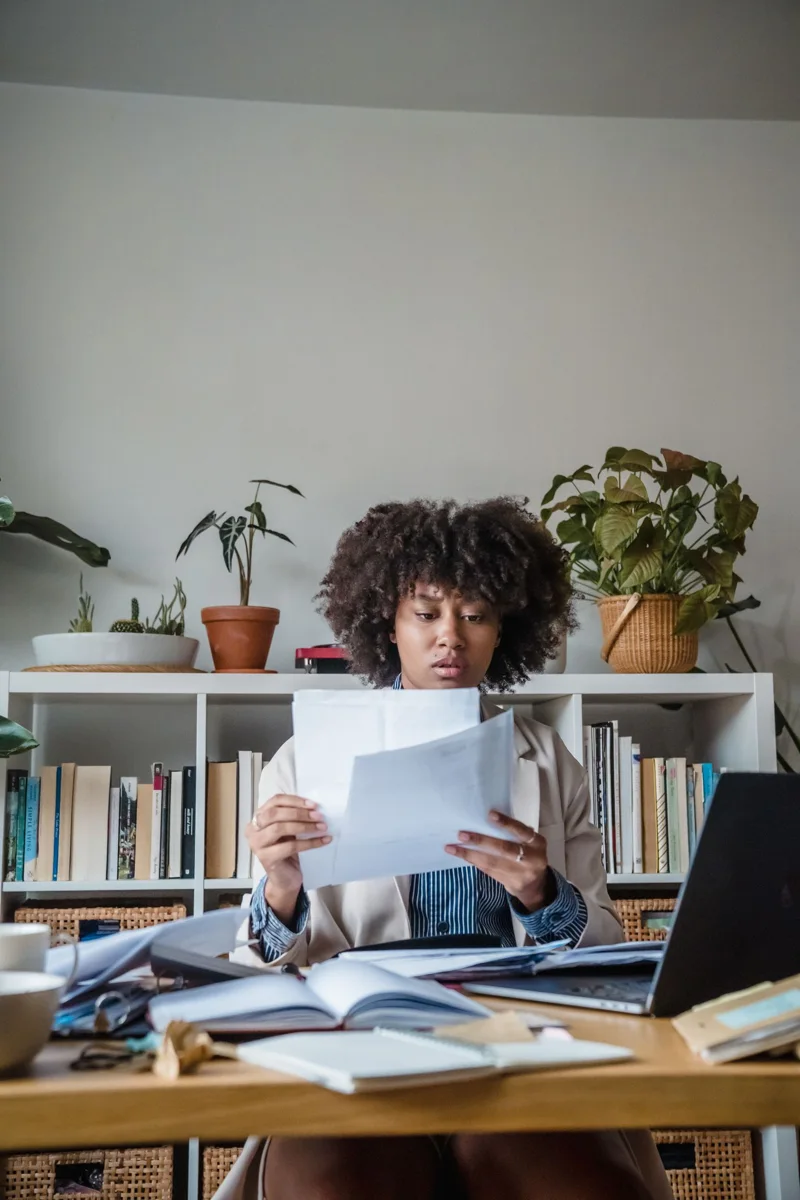 Person reading documents at a table.
