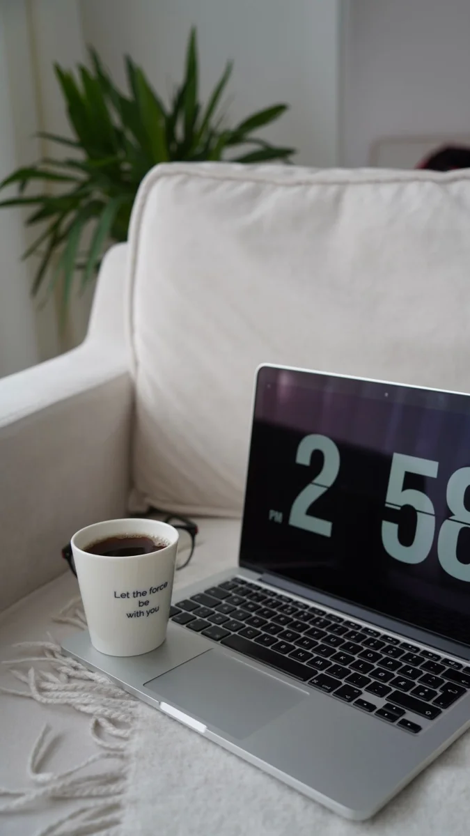 Laptop with coffee nearby.