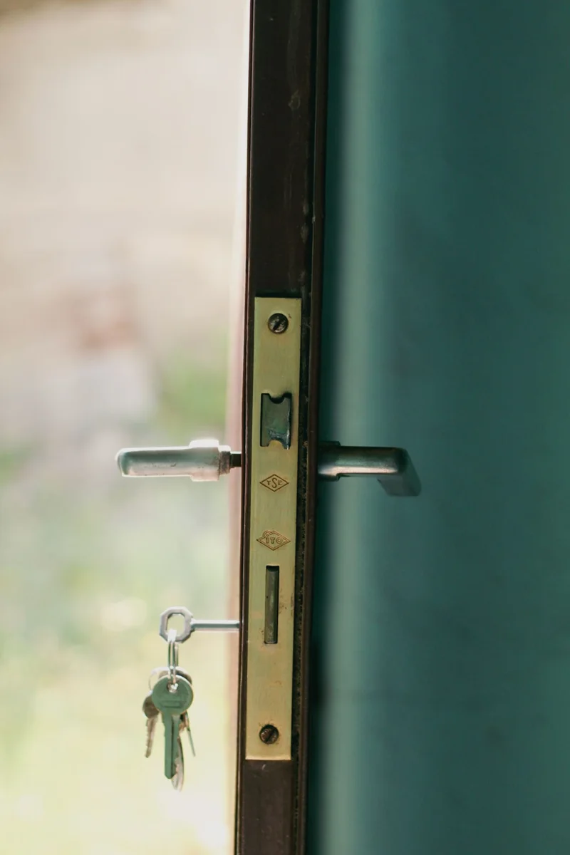 Keys in the lock of an open door.