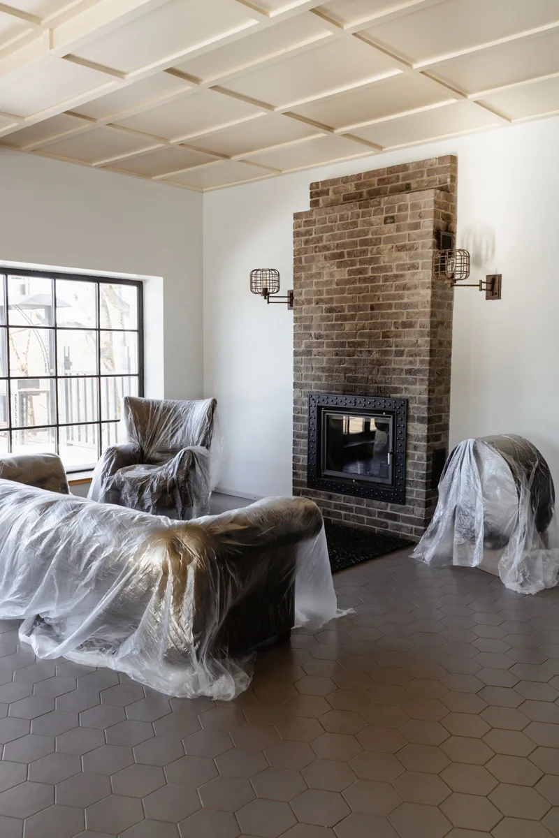 Living-room furniture covered with plastic during renovation.
