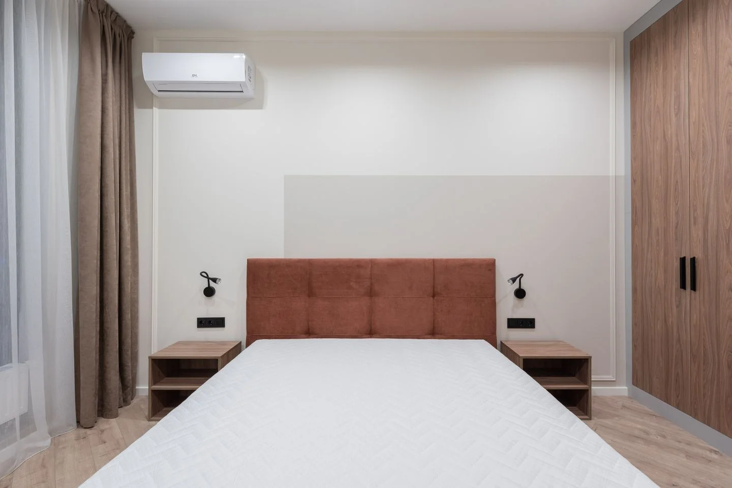 A bedroom furnished with a bed and wardrobe