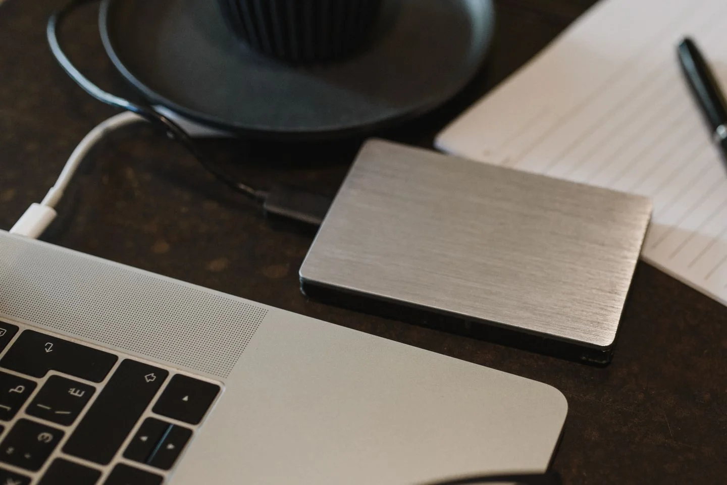An external hard drive beside a laptop