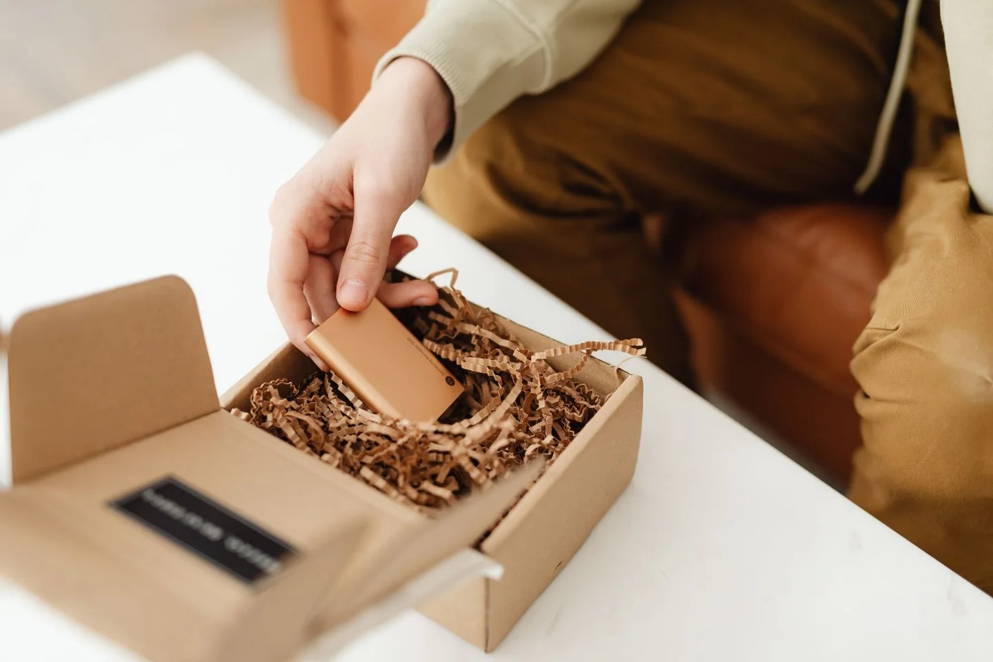 Someone unpacks a new object from a box